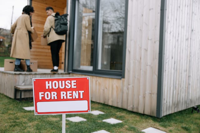 house%20for%20rent%20sign%20in%20front%20of%20two%20people